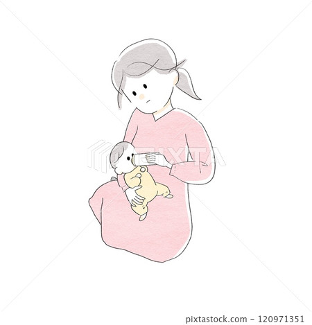 A woman sitting and feeding her baby 120971351