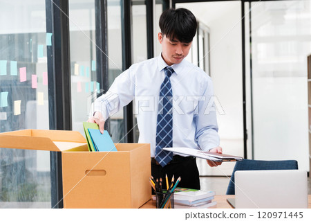 Employee packing belongings into a box during a job change or resignation 120971445
