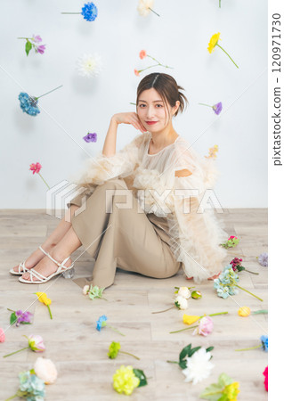 Portrait of a middle-aged woman surrounded by flowers 120971730