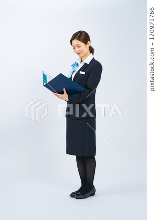 Full-body photo of a middle-aged woman in a suit holding a file and serving customers 120971766