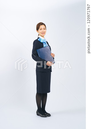 Full body photo of a middle-aged woman in a suit holding a file 120971767