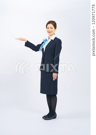 Full-body photo of a woman in the service industry guiding customers 120971778
