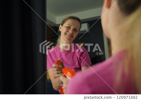 A woman is cleaning her living room at home A woman is cleaning her living room at home 120971882