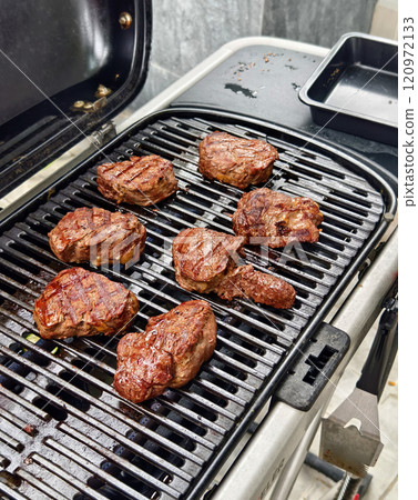 Sizzling grilled meat that showcases a perfect char 120972133