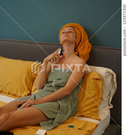 Young woman using infrared massager Young woman using infrared massager 120972300