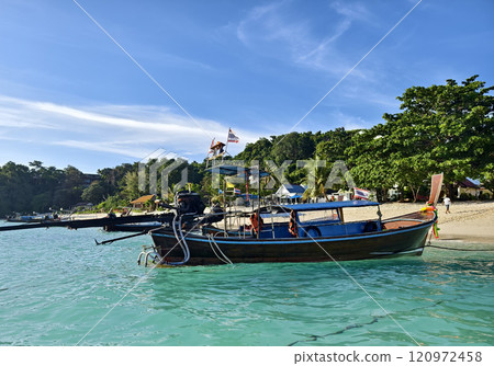 A vibrant, picturesque beach scene showcasing colorful boats 120972458