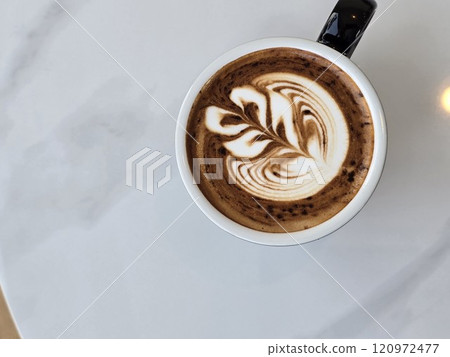 Artistic Latte in Black Mug on Wooden Table 120972477