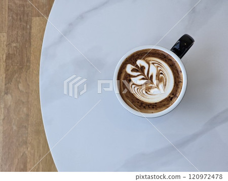 Artistic Latte in Black Mug on Wooden Table 120972478