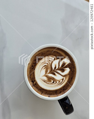 Artistic Latte in Black Mug on Wooden Table Artistic Latte in Black Mug on Wooden Table 120972481