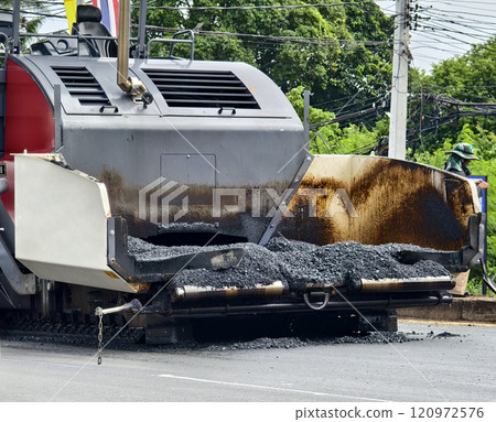 Asphalt paving machine laying down asphalt Asphalt paving machine laying down asphalt 120972576