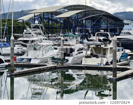 A tranquil and serene marina scene featuring various boats A tranquil and serene marina scene featuring various boats 120972624