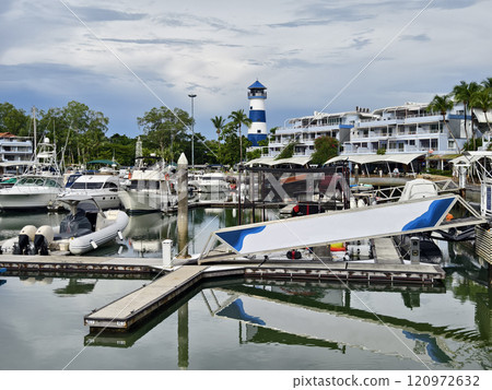 A tranquil and serene marina scene featuring various boats 120972632
