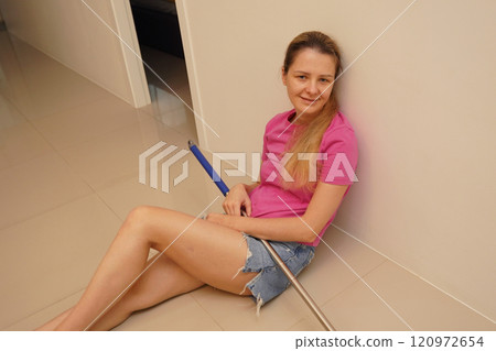 A woman is cleaning her living room at home A woman is cleaning her living room at home 120972654
