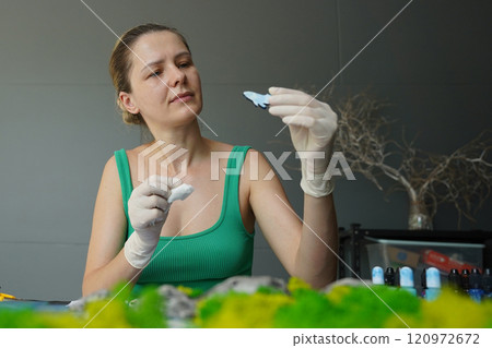 The process of making the art decor of epoxy resin, natural stones and moss 120972672