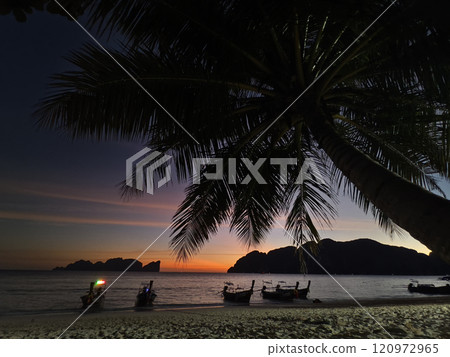A stunning sunset is casting vibrant hues of color over a tranquil ocean A stunning sunset is casting vibrant hues of color over a tranquil ocean 120972965