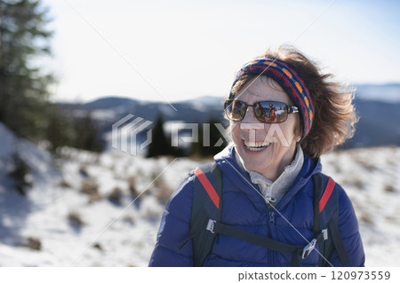 Winter hike for an elderly man in snowy mountains. Active senior enjoying nature. Winter hike for an elderly man in snowy mountains. Active senior enjoying nature. 120973559