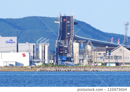 A photo of the steep slope of the Eshima Bridge (also known as Betafumizaka) towards Matsue taken with a telephoto lens from the shore of Daikon Island in Lake Nakaumi. A photo of the steep slope of the Eshima Bridge (also known as Betafumizaka) towards Matsue taken with a telephoto lens from the shore of Daikon Island in Lake Nakaumi. 120973604