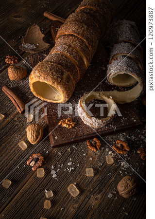 Chimney cake on a rustic wooden board Chimney cake on a rustic wooden board 120973887