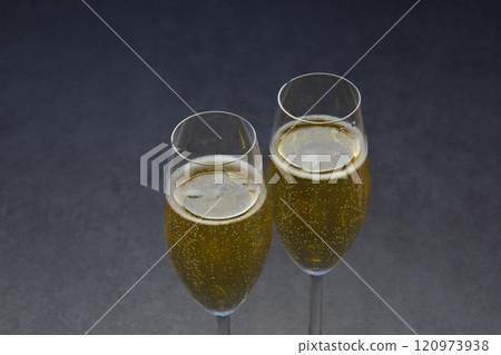An image of a toast with two flute glasses filled with chilled champagne (sparkling wine) 120973938