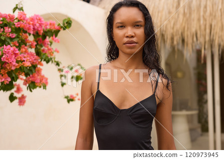 Summer Fashion. Woman Posing Outdoors with Vibrant Pink Flowers in Background 120973945