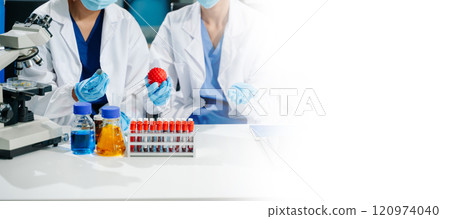 scientists in lab coats conducting research, handling glassware, and working with chemicals 120974040