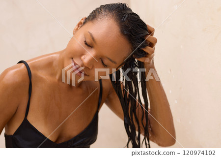 Woman Relaxing While Gently Washing Her Hair in the Shower 120974102