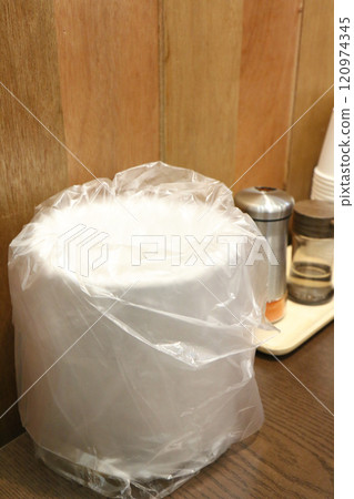 A trash can on a restaurant table (Korea) 120974345