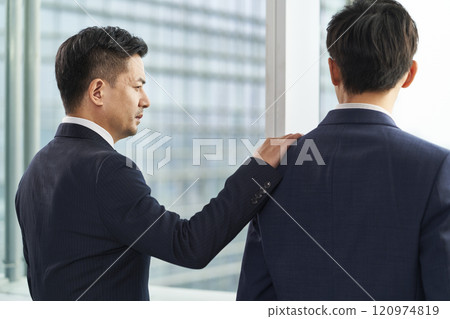 two asian businessmen chatting in office 120974819
