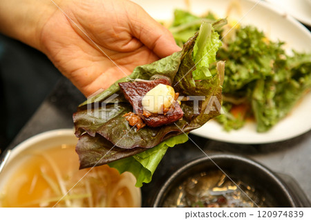 Korean barbecue food. Lettuce , Sesame leaf and meat wrap Korean barbecue food. Lettuce , Sesame leaf and meat wrap 120974839