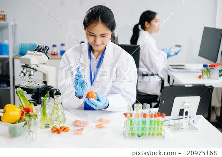Food science as lab scientists test and analyze vegetables for safety and quality using advanced technology 120975168