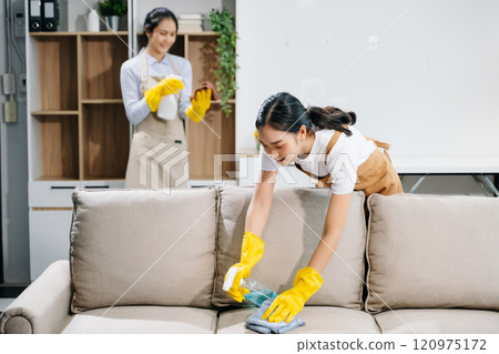 Efficient and professional housekeeping with our dynamic cleaning duo. Perfect teamwork ensures spotless cleanliness in home. 120975172