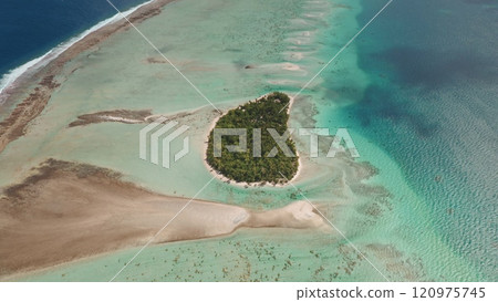 Small wild island covered green palm trees in Tikehau atoll, Tuamotu archipelago in French Polynesia. Breathtaking aerial view of coral reef barrier turquoise lagoon and vast expanse of pacific ocean Small wild island covered green palm trees in Tikehau atoll, Tuamotu archipelago in French Polynesia. Breathtaking aerial view of coral reef barrier turquoise lagoon and vast expanse of pacific ocean 120975745
