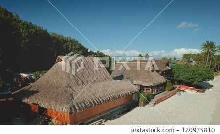 Luxury hotel huts bungalows in Bora Bora, French Polynesia. Tropical island beach lagoon tranquil escape. Perfect summer holiday, remote wild nature paradise, exotic travel. Aerial zoom out panorama 120975810