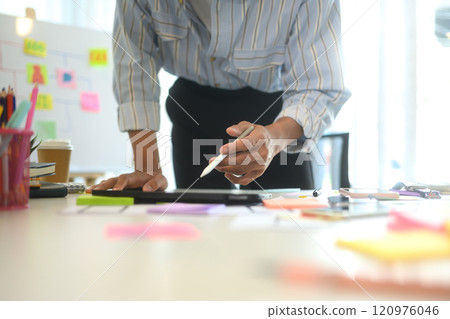 Close up of designer working with app layouts and sketches in a modern workspace Close up of designer working with app layouts and sketches in a modern workspace 120976046