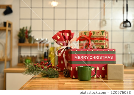 Beautiful Christmas gift boxes, coffee mug and festive decor on wooden countertop Beautiful Christmas gift boxes, coffee mug and festive decor on wooden countertop 120976088