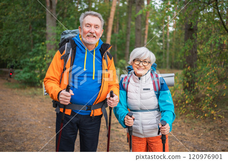 Hiking tourism adventure. Senior couple man woman enjoying outdoor recreation hiking in forest. Happy old people backpackers hikers enjoy walking hike trekking tourism active vacation beauty of nature Hiking tourism adventure. Senior couple man woman enjoying outdoor recreation hiking in forest. Happy old people backpackers hikers enjoy walking hike trekking tourism active vacation beauty of nature 120976901