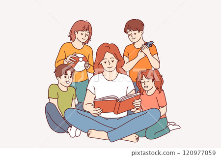 Woman kindergarten teacher reads book to children who are listening with interest to new fairy tale 120977059