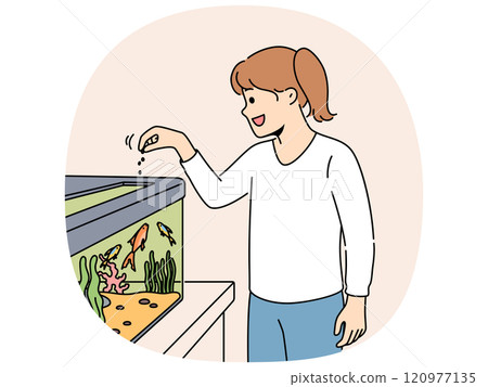 Little girl feeds fish in aquarium and watches underwater pets swimming with pleasure 120977135