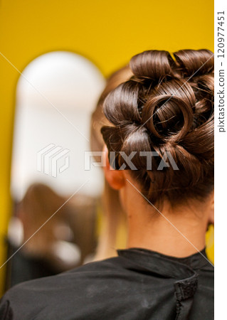 An elegant updo hairstyle beautifully showcased with a stunning mirror reflection effect An elegant updo hairstyle beautifully showcased with a stunning mirror reflection effect 120977451