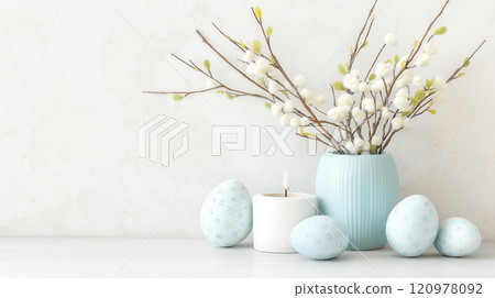 Festive arrangement showcases pussy willow branches, decorated eggs, and a candleholder created with natural materials Festive arrangement showcases pussy willow branches, decorated eggs, and a candleholder created with natural materials 120978092