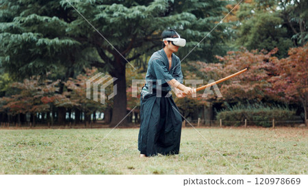 Virtual reality, nature and Asian man with sword for martial arts, Kendo practice and exercise. Culture, heritage and person with shinai, VR tech and goggles for skills, fight and training in Japan 120978669
