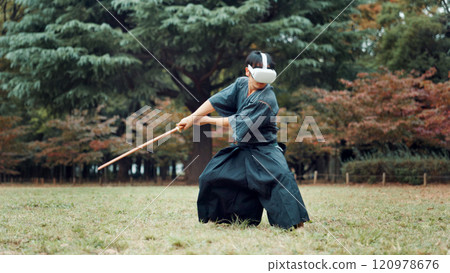 VR, nature and Asian man with sword for martial arts, Kendo practice and exercise. Culture, heritage and person with shinai, virtual reality tech and goggles for skills, fight and training in Japan 120978676