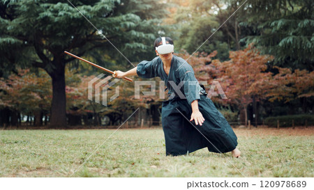 Virtual reality, park and Asian man with bamboo sword for martial arts, Kendo practice and exercise. Culture, Japan heritage and person with shinai, VR tech and goggles for skills, fight and training 120978689