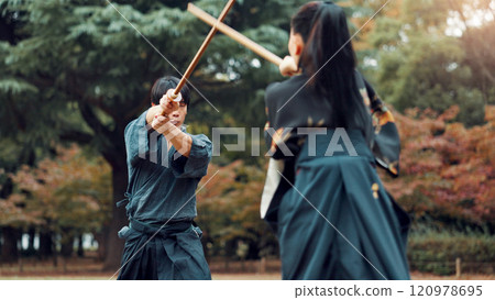 Weapon, Japanese people and outdoor for martial arts or aikido in training, exercise and sports. Students, wooden sword and heritage for challenge, combat and practice as defense technique or bojutsu 120978695