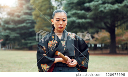 Portrait, martial arts and Asian woman with bamboo sword in park for technique, Kendo practice and exercise. Culture, bokuto and person with shinai for skills, fight and traditional training in Japan Portrait, martial arts and Asian woman with bamboo sword in park for technique, Kendo practice and exercise. Culture, bokuto and person with shinai for skills, fight and traditional training in Japan 120978696