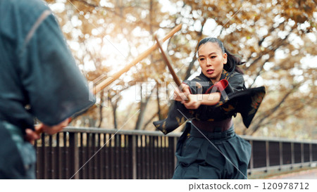 Trainer, bamboo sword and Asian woman in city for martial arts, Kendo practice and exercise. Culture, Japan heritage and person and sensei with shinai, bokuto and weapon for skill, fight and training 120978712