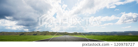 Asphalt street with mountain range with blue sky and clouds in the background 120978727