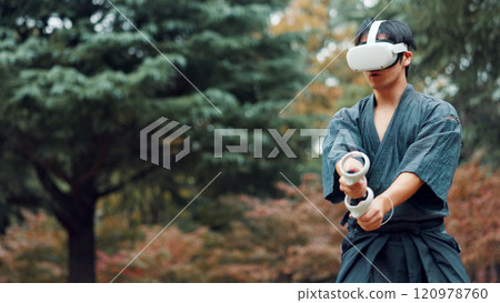Virtual reality, controller and Asian man with technology for martial arts, Kendo practice and exercise. Culture, Japan and person with shinai, VR goggles and metaverse for skill, fight and training 120978760