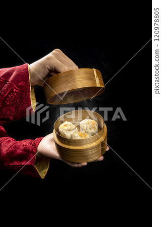Chinese person showing dim sum dumpling on bamboo wooden basket bowl 120978805