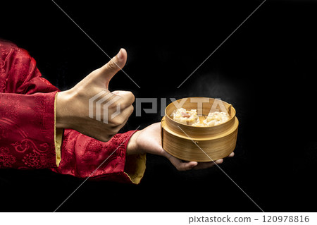 Chinese person showing dim sum dumpling on bamboo wooden basket bowl 120978816
